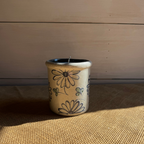 Rowe Pottery handmade stoneware candle crock in a hand decorated daisy pattern
