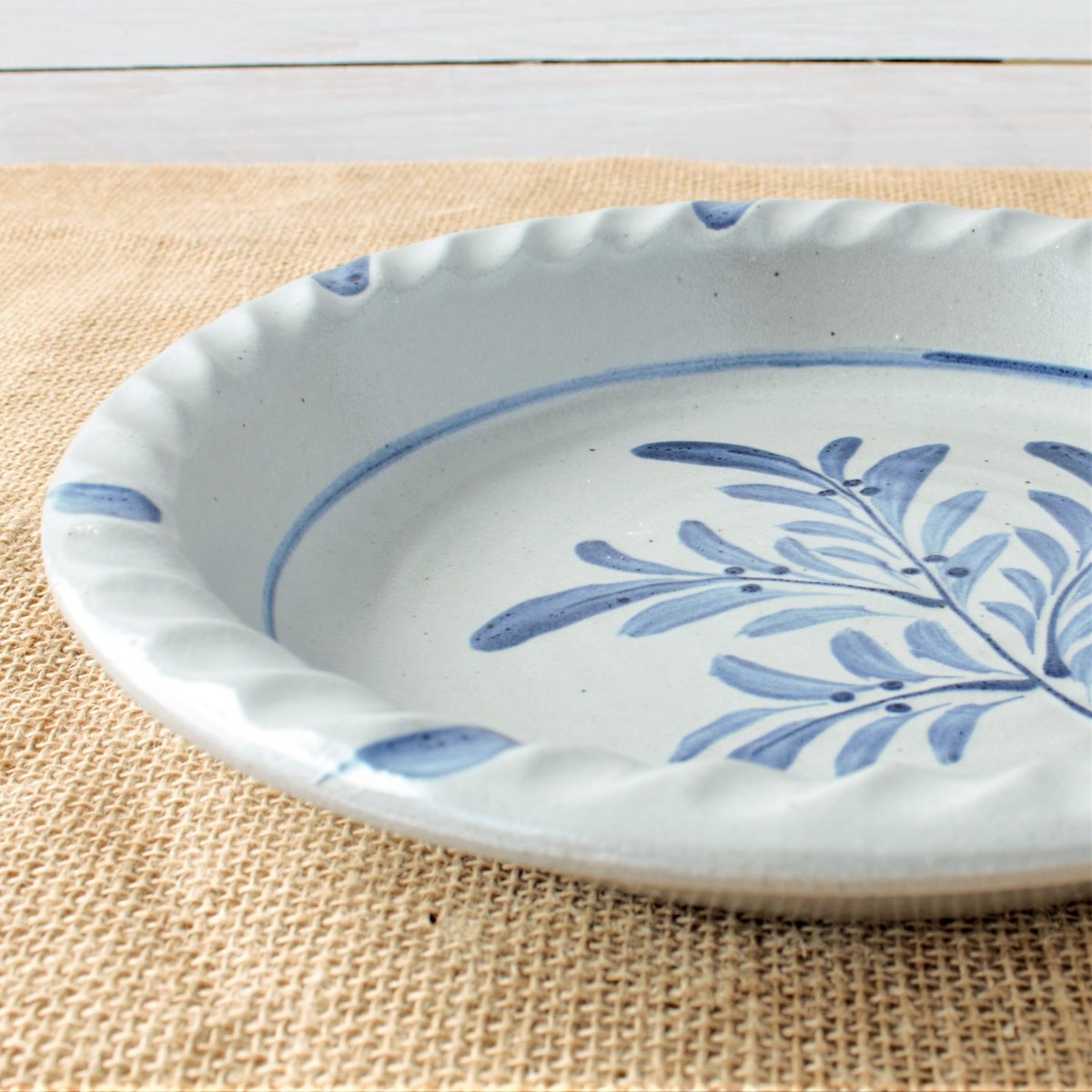 Rowe Pottery handmade stoneware pie plate with Teaberry pattern zoomed in detail view