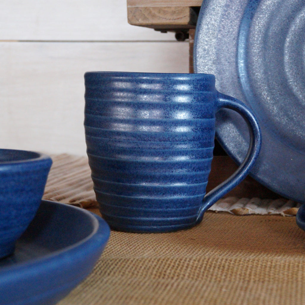 Rowe pottery hand thrown denim ridges mug with decorative background