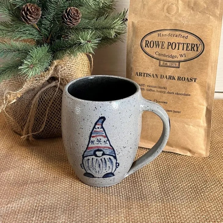 Rowe Pottery Hand thrown stoneware mug In a hand decorated Gnome pattern with rowe pottery artisan dark roast coffee beans in the background