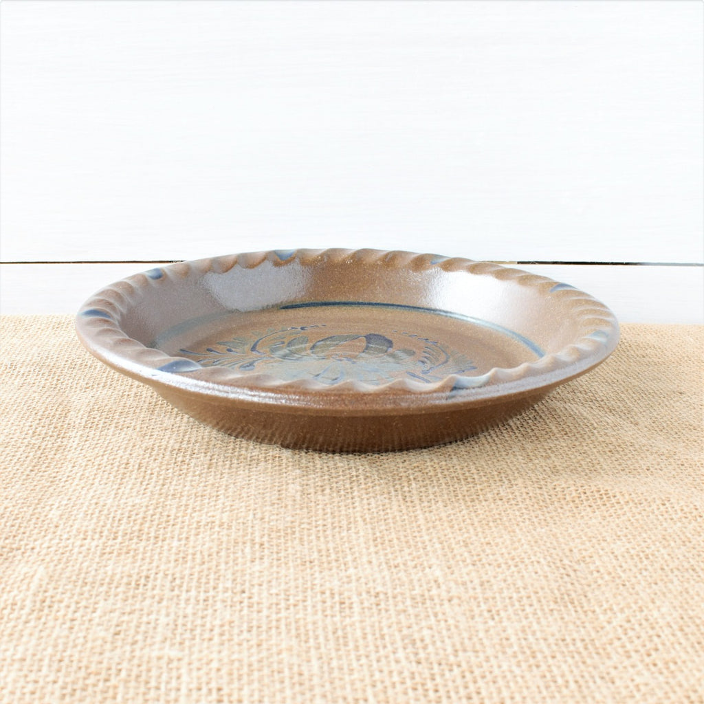 Rowe Pottery handmade stoneware pie plate with Provincial pattern low angle view