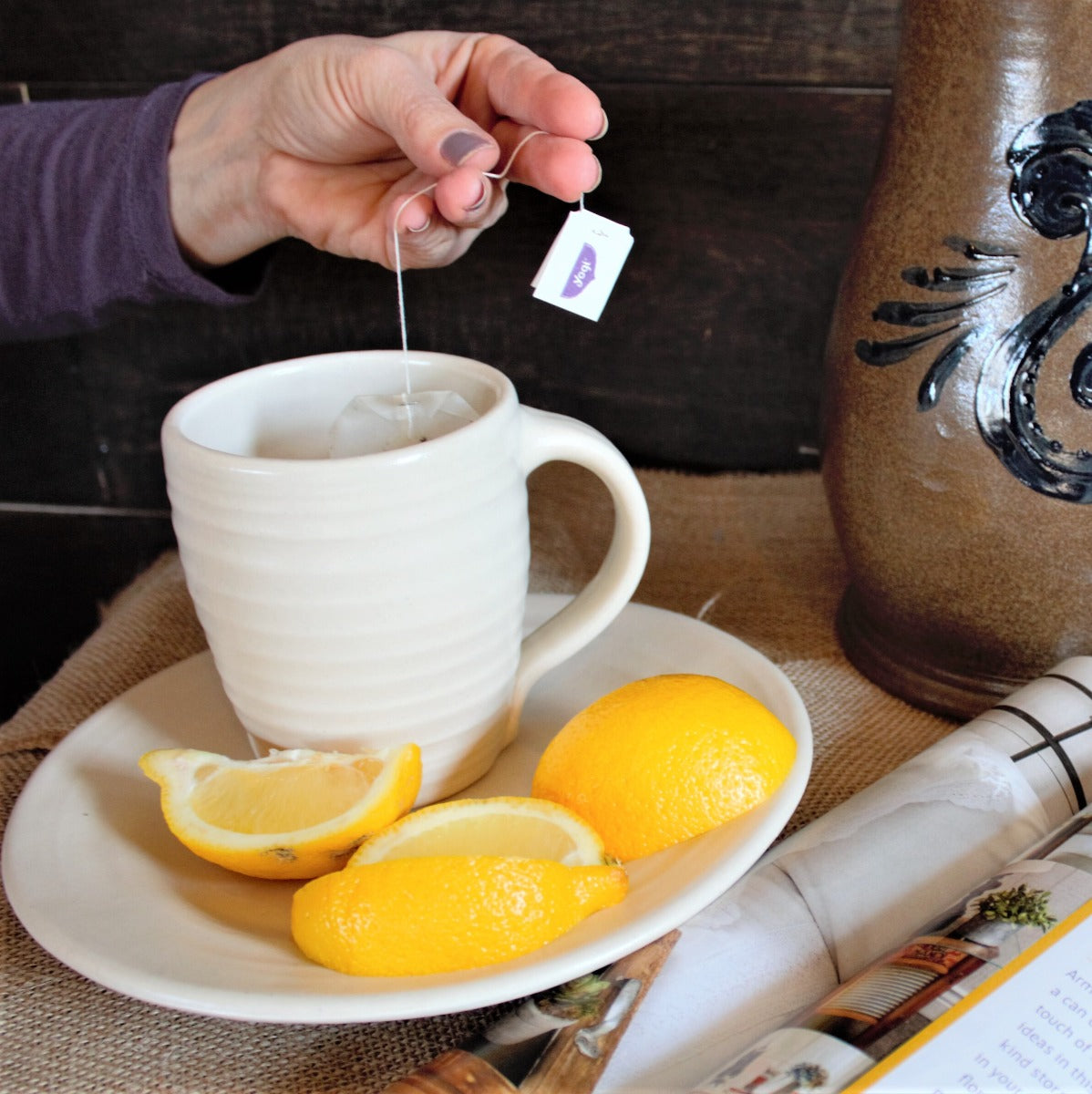 Rowe Pottery hand thrown farmhouse white ridges mug with tea on white ridges plate with lemons