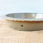 Rowe Pottery handmade stoneware deep dish pie plate with Farm Floral pattern low angle view