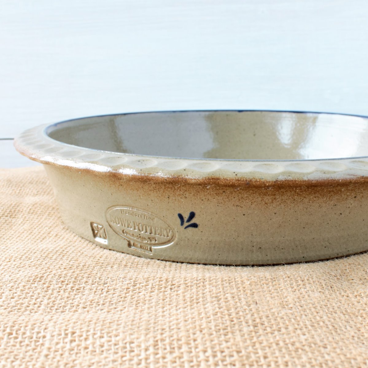Rowe Pottery handmade stoneware deep dish pie plate with Farm Floral pattern low angle view