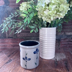 Rowe Pottery handmade stoneware candle crock in a hand decorated petals in bloom pattern in decorative setting