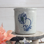 Rowe Pottery handmade stoneware candle crock in a hand decorated Dhalia pattern decorative background