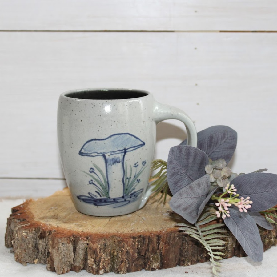 Rowe Pottery Hand thrown stoneware mug In a hand decorated Mushroom pattern on wood stump with flowers