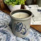 Rowe Pottery handmade stoneware candle crock in a hand decorated Dhalia pattern on table setting