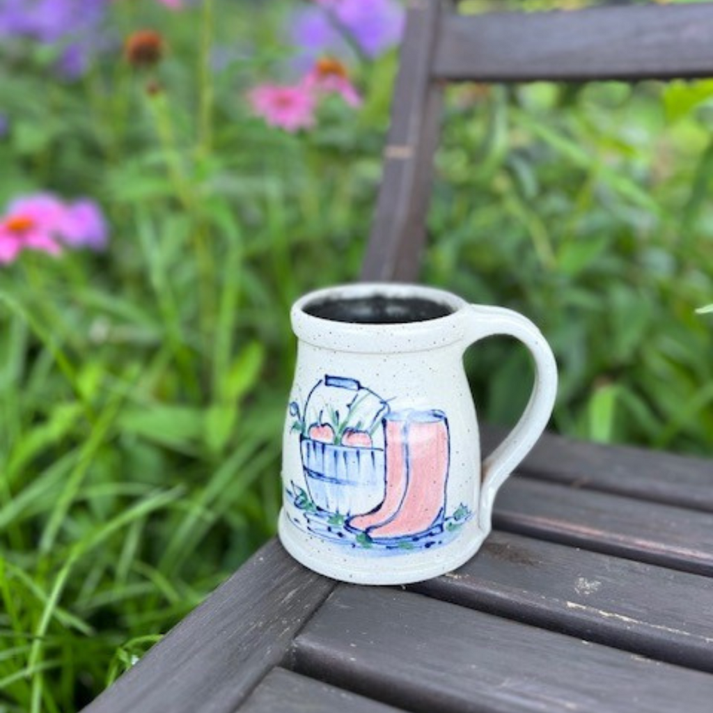 Rowe Pottery Hand thrown stoneware mug In a hand decorated Boots pattern with beautiful flower background